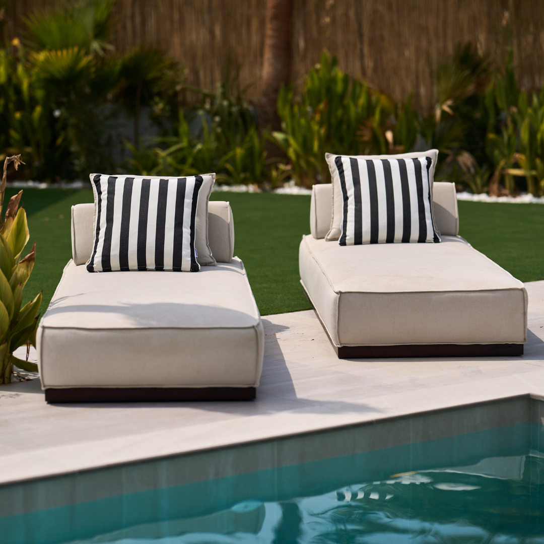 Set of two monochrome outdoor cushions from homesoda.store featuring sleek black fabric and plush padding for outdoor comfort.