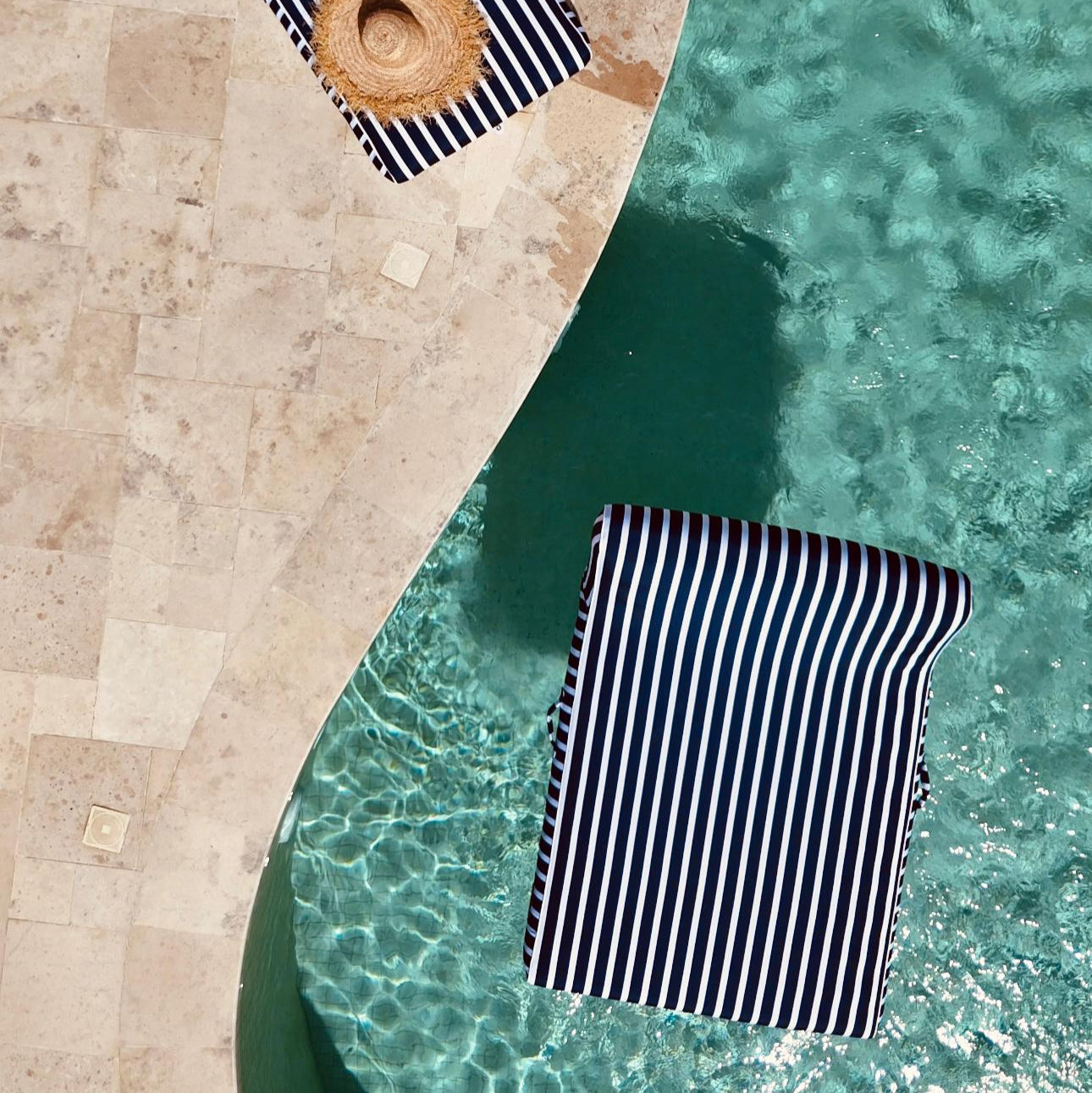 Navy and white striped upholstered lilo, a luxury product for people with private pools