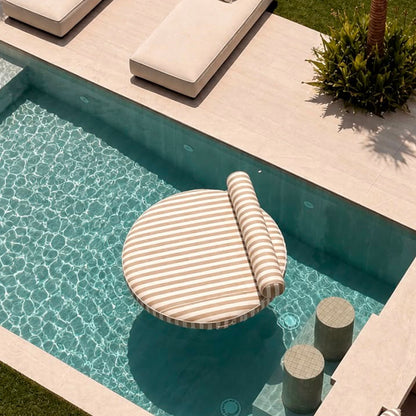 Outdoor lounge area with poolside furniture and palm trees