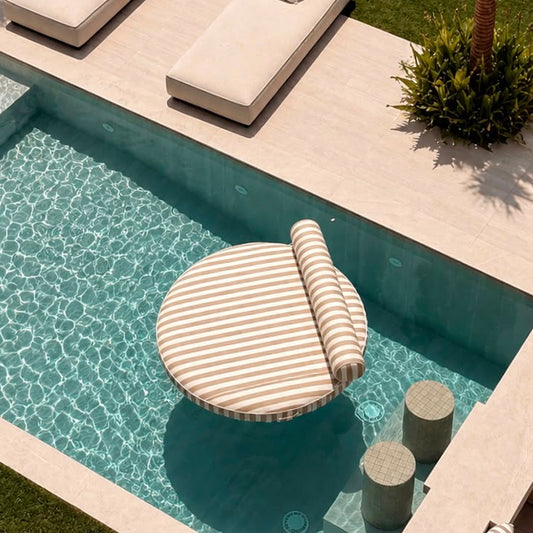 Outdoor lounge area with poolside furniture and palm trees